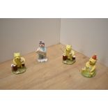 A group of three Royal Doulton bone china Disney Winnie The Pooh figures, Pooh Counting The Honey