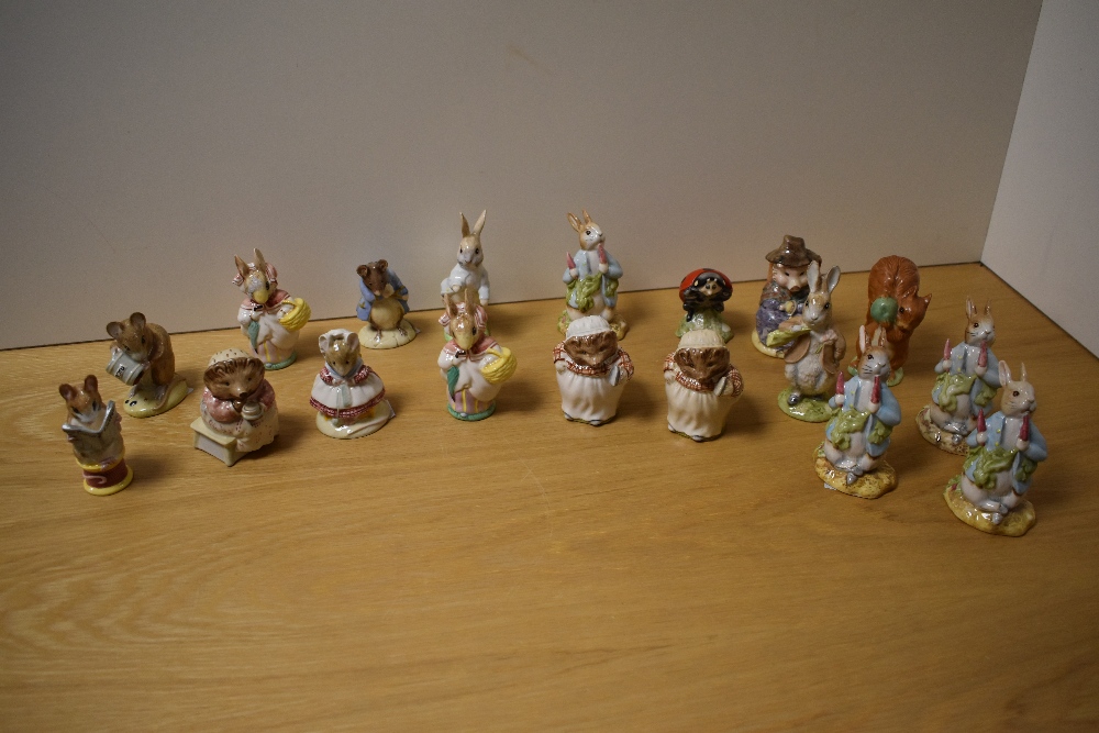 A collection of sixteen Royal Albert and two Beswick Pottery Beatrix Potter figures, to include