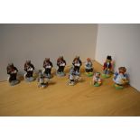 A group of eleven collectible Wade porcelain figures, comprising five 'Newark 1998' travelling