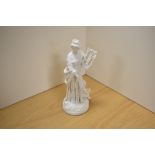 A 19th/20th century Parian ware bisque porcelain figure of Sappho and lyre with putto seated at