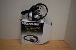 A pair of Bose boxed around ear headphones