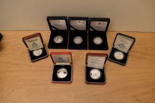 A collection of GB Silver Proof Five Pound Coins in cases with certificates, Golden Wedding 1997,