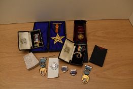 Seven cased Masonic Jewels including two Silver, Masonic miniature book, Masonic Soap Stone marked