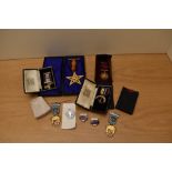 Seven cased Masonic Jewels including two Silver, Masonic miniature book, Masonic Soap Stone marked