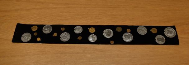 A collection of Coronation Medallions, Queen Victoria, Edward VII & George V all on display sash