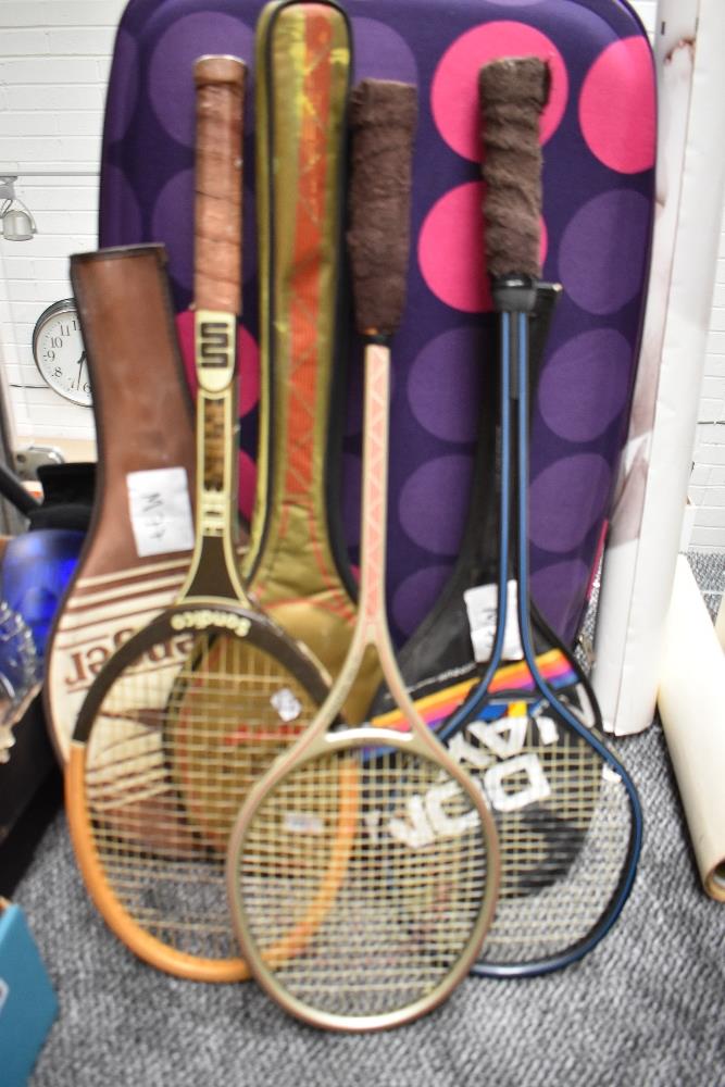 Three retro badminton rackets.