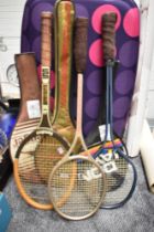 Three retro badminton rackets.