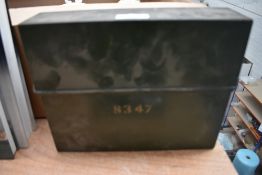 A vintage metal letter rack with lid, possibly military.