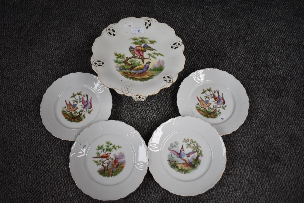 A continental porcelain comport decorated with exotic birds on cream ground, sold together with four