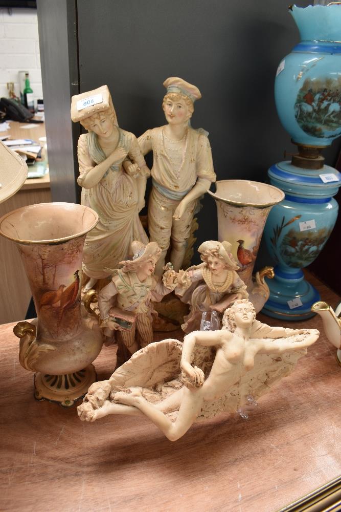 Four Royal Dux style bisque figures, a pair of Crown Devon 'Game' vases in need of restoration and a