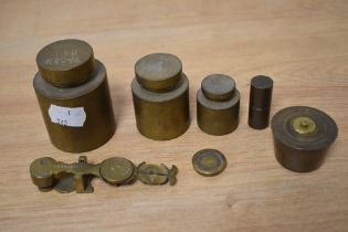 Three vintage cylindrical brass graduated weights, 1kg to 200g, plus other weights, and a set of
