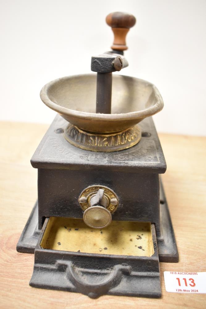 A late 19th Century T. & C. Clark & Co. cast iron coffee grinder, measuring 15cm high - Image 2 of 2