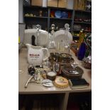 A collection of vintage bar accessories including three glass decanters, measures, bottle openers,