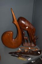 An African carved hardwood antelope and calf, measuring 45cm tall, another large carved wooden
