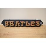 An eye catching hand made Beatles sign, having chunky gilt painted lettering on an ebonised panel,