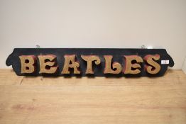 An eye catching hand made Beatles sign, having chunky gilt painted lettering on an ebonised panel,