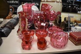 A collection of approximately 16 pieces of cranberry glass including a Jack-in-the-pulpit vase, a