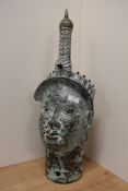 A large Nigerian / Benin brass head depicting Oba, wearing crown or head dress, with face pierced to