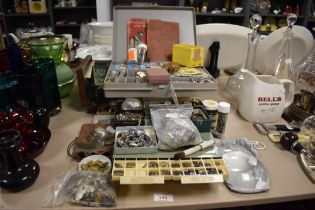 A extensive collection of horologist parts and tools including lenses, mechanical parts, watch faces