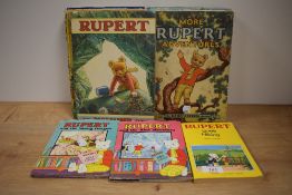 Eleven vintage Rupert Annuals ranging throughout the 1970's and three smaller Rupert books.