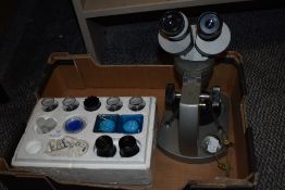 A vintage Olympus VT-11 microscope with lenses and specimen holders sold along with a watch makers