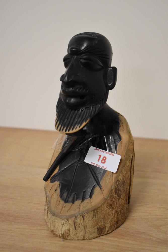 A lignum vitae carved maize picker bust, with pipe, incised signature to underside.