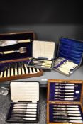 A 19th/20th Century John Hunt oak cased canteen of ivorine handled cutlery, together with four other