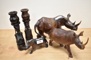 A pair of African hardwood carved figural candle holders, measuring 23cm tall, and three hardwood