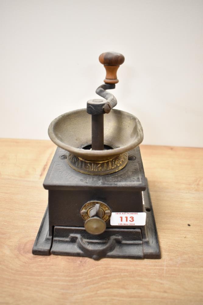 A late 19th Century T. & C. Clark & Co. cast iron coffee grinder, measuring 15cm high