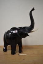 A 20th century African carved lignum vitae elephant having simulated ivory tusks,one tusk af.