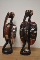 Two 20th century African carved and painted wood guardian birds, possibly Baga, largest being 46cm
