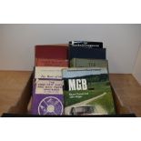A small carton of classic car related books.