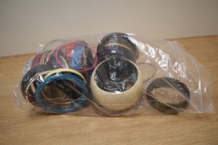 An assortment of costume bracelets including wooden bangles, statement bangles and paste set bangles