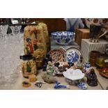 A collection of Oriental items including vases, bowls, mudmen and Buddha's etc.