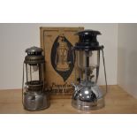 A vintage chrome metal Vapalux Pressure Lantern with box and another storm lantern, the largest