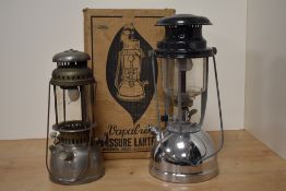 A vintage chrome metal Vapalux Pressure Lantern with box and another storm lantern, the largest