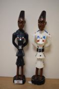 Two 20th Century African painted studies of policemen, each measuring 30cm tall (2)