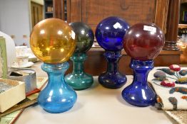 Four decorative glass balls/buoys and four hyacinth bulb vases.