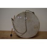 An African / Nigerian animal skinned drum, with drumstick.