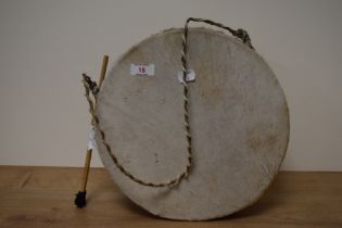 An African / Nigerian animal skinned drum, with drumstick.