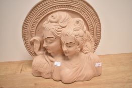An Art Deco style plaster statuette, modelled as the busts of two elegant women against a decorative