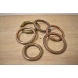 A collection of brass and copper curtain rings