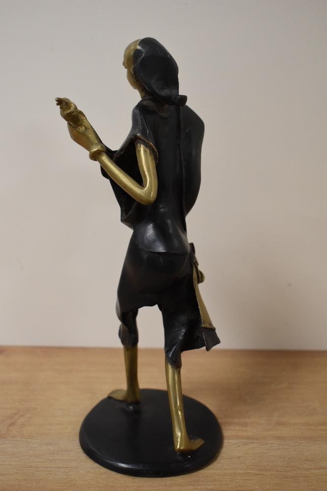 A 20th century African bronze musician figure with patinated garments and circular base and marked B - Image 2 of 2