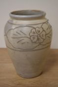 A mid-20th Century studio pottery vase, decorated with a band of flowers against a beige ground,