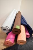 Six yoga mats and a selection of blocks in a large bag.