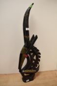 A 20th century African brass mounted and carved wood antelope, scratched mark to underside, 63cm