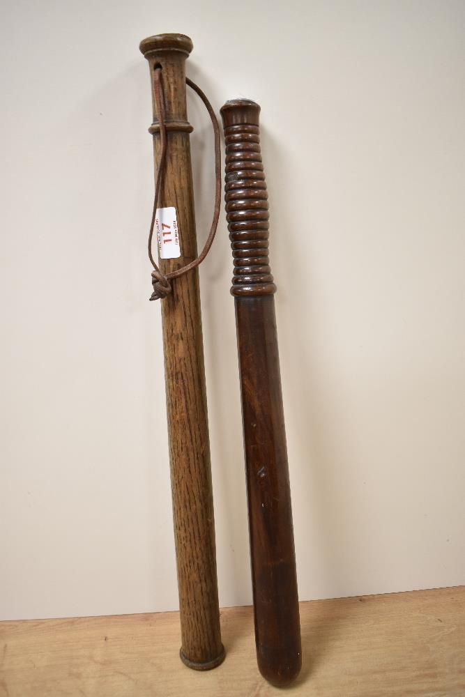 A Victorian hardwood truncheon with turned grip, measuring 46cm long, and another with string grip