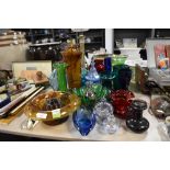 A selection of vintage glass in various colours including decanter and vases.