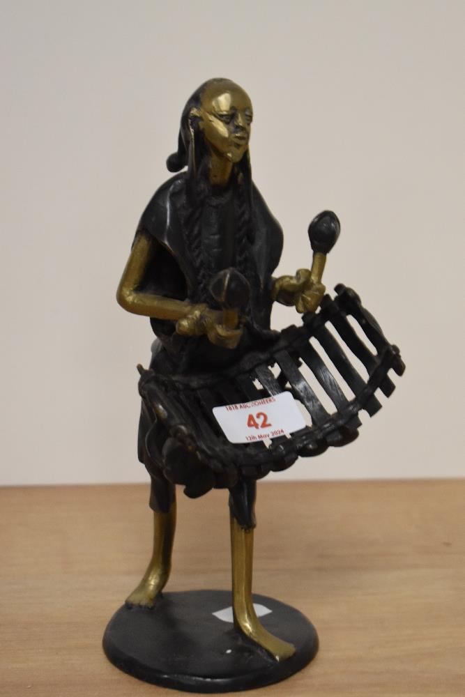 An African 20th century cast and patinated brass musician, approx 24cm.