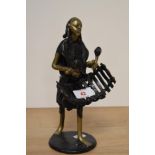 An African 20th century cast and patinated brass musician, approx 24cm.